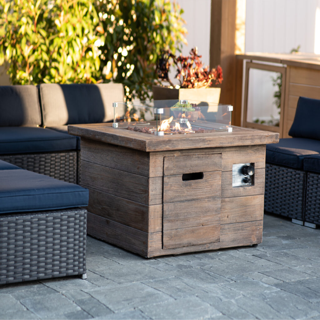 A cozy patio with a wooden propane fire pit, perfect for enjoying the warmth of a crackling fire in Riverside.
