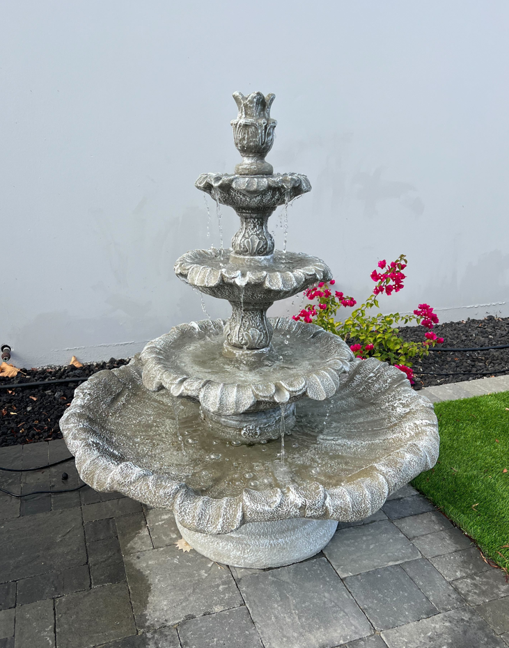 A beautiful concrete garden fountain surrounded in Temecula