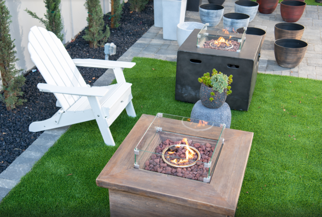 A lawn featuring a patio chair, fire pit, and planters perfect for Temecula, San Diego, Riverside, California outdoor space.